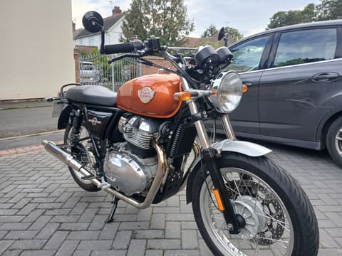 Bob, the 2020 Royal Enfield Interceptor 650, three-quarter front view showing the orange tank and bar-end mirrors